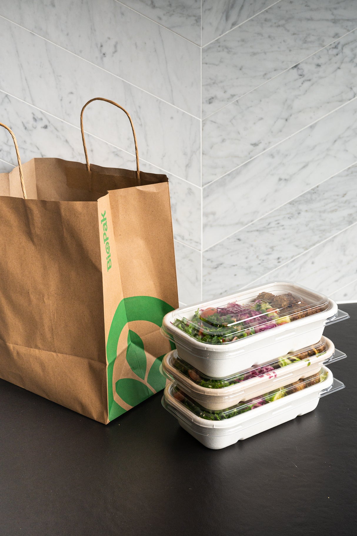 rectangular takeaway bowl and recyclable lid stacked up ready for delivery