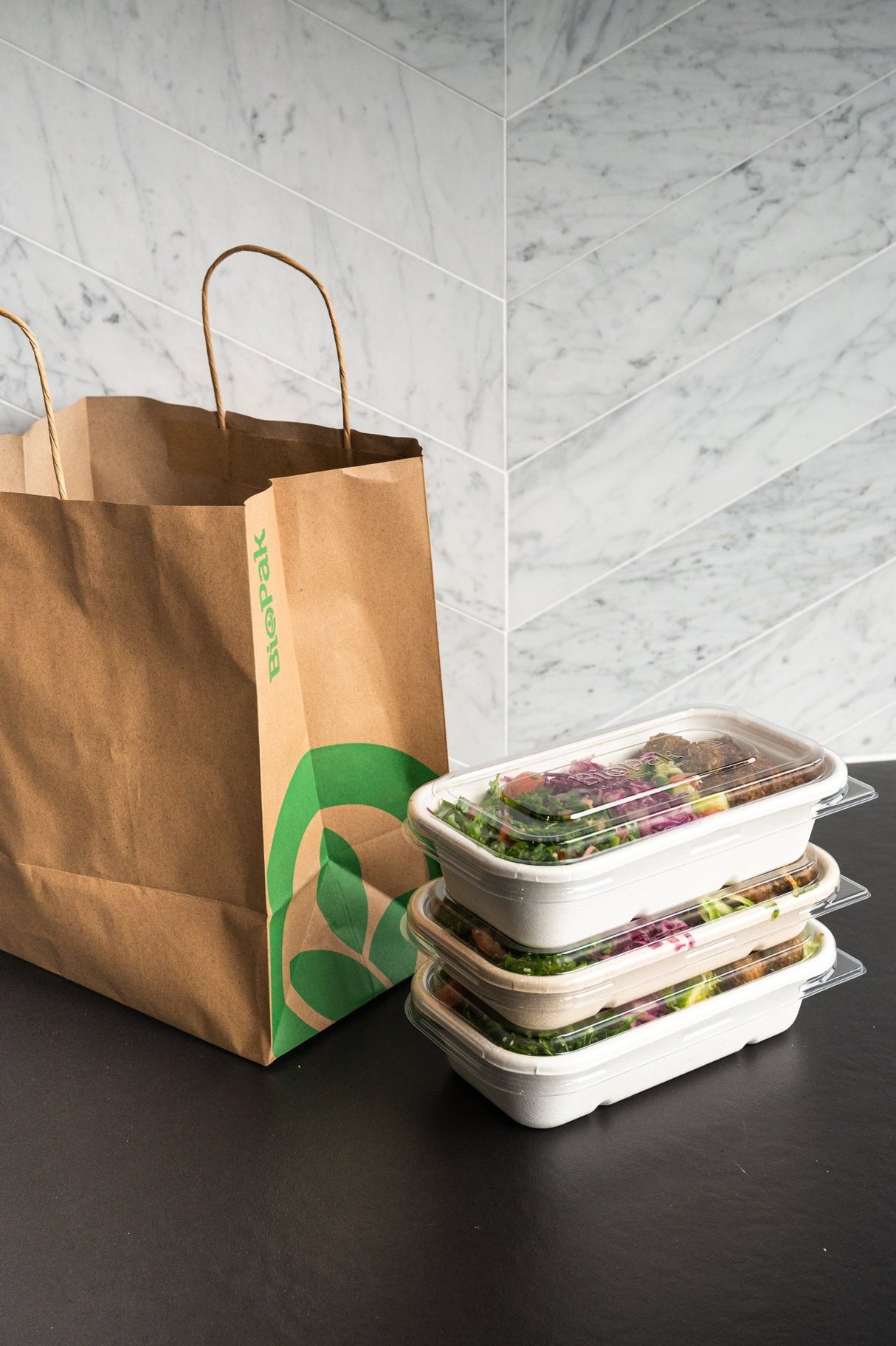 rectangular takeaway bowl and recyclable lid stacked up ready for delivery