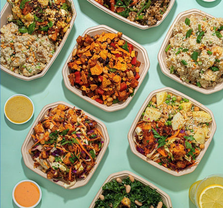 octagonal takeaway containers made from bagasse sugarcane laid out on a table serving vibrant healthy takeout foods