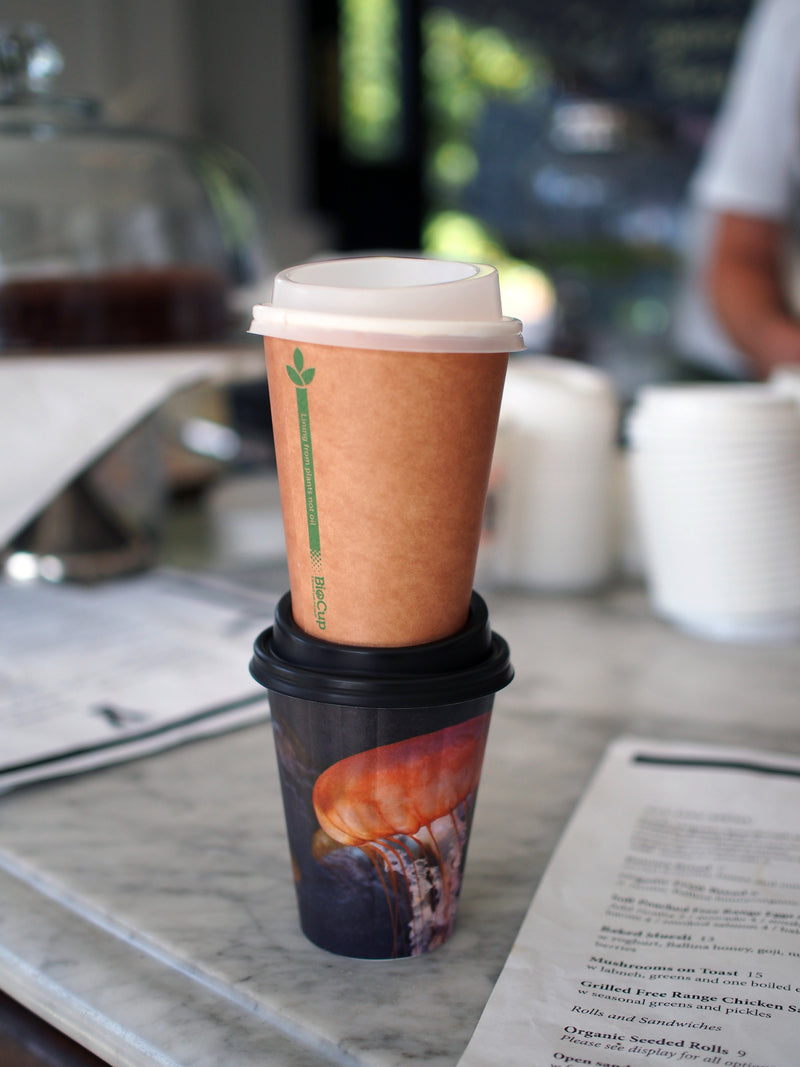 two single wall 12oz coffee cups stacked on top of each other with pla disposable lids