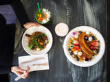disposable bagasse plates with bagasse bowls and a cold takeaway drink cup