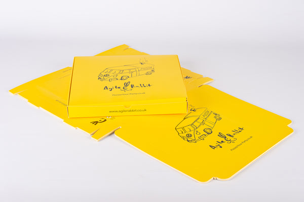 custom printed flat pack pizza box in yellow on a white background