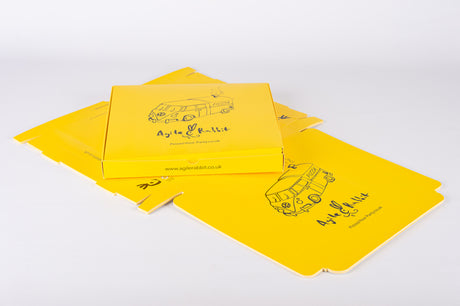 custom printed flat pack pizza box in yellow on a white background